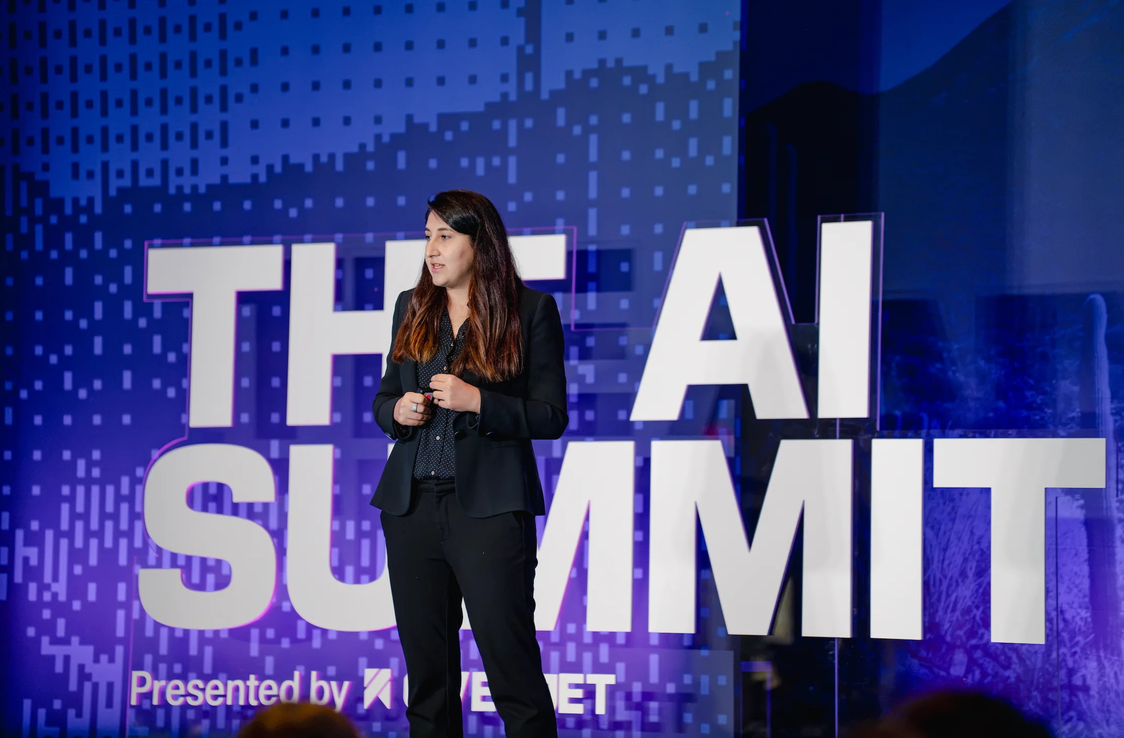 Wardah Inam on the main stage in front of The AI Summit backdrop