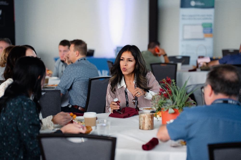 Attendees having breakfast together in the pavilion