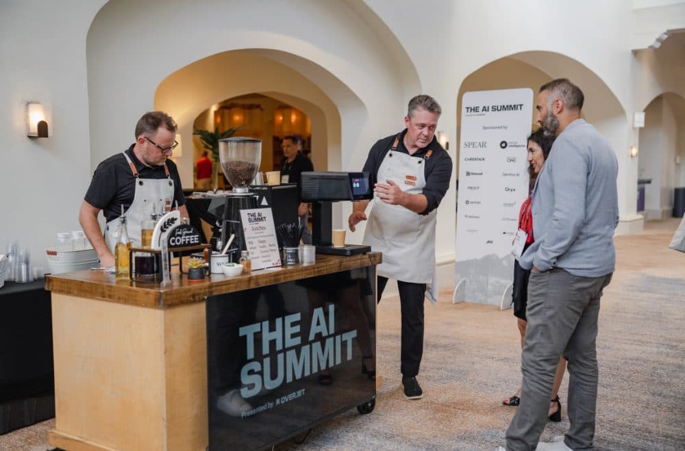 Baristas serving at The AI Summit coffee cart