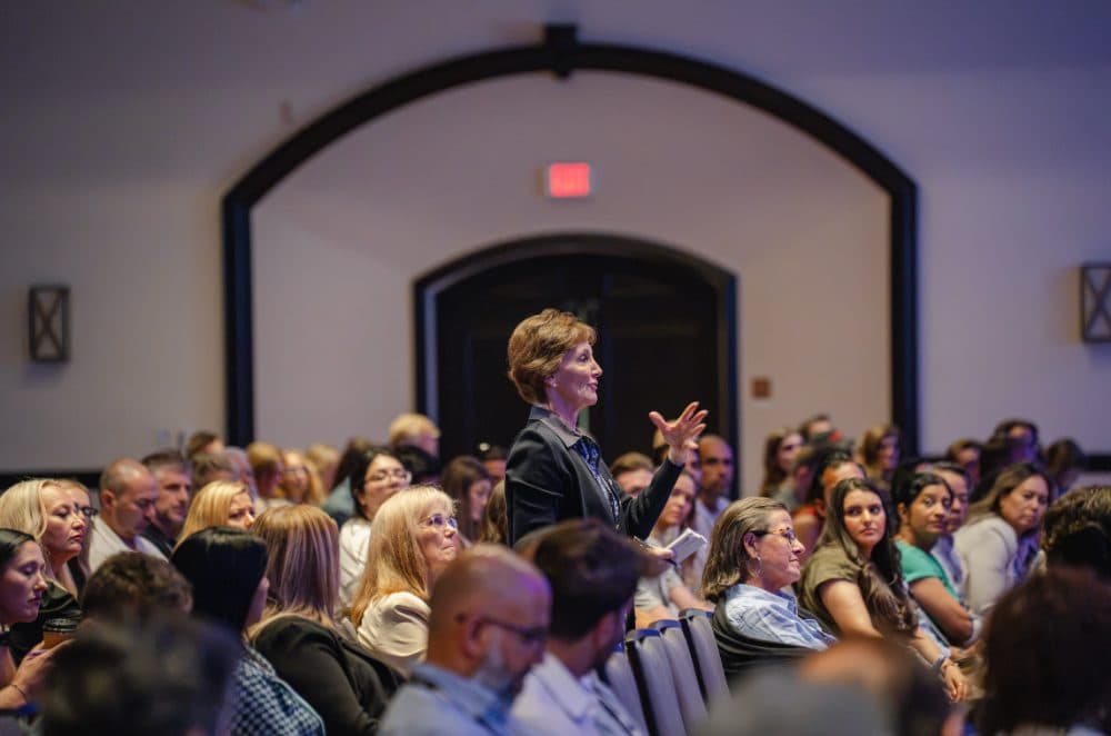 Audience member standing to ask a question in the main stage room