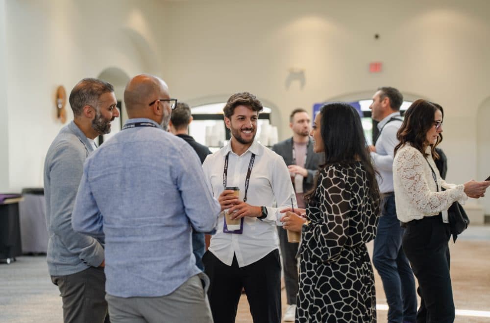 Attendees chatting over coffee between sessions