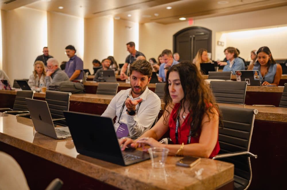 Two attendees at a laptop during a Let's Build session