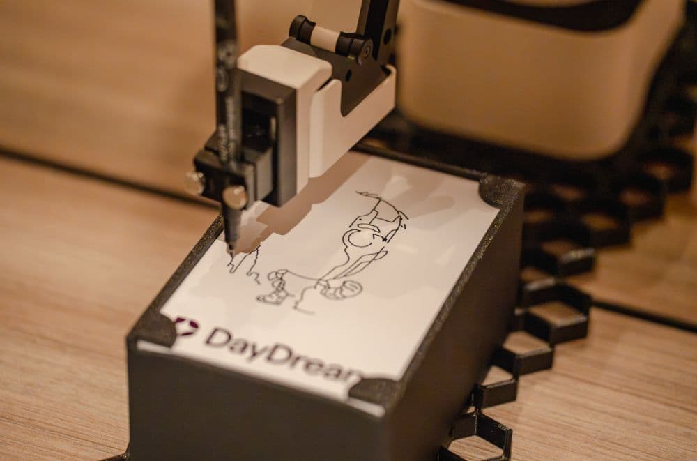 Robotic arm drawing a caricature at the Daydream station