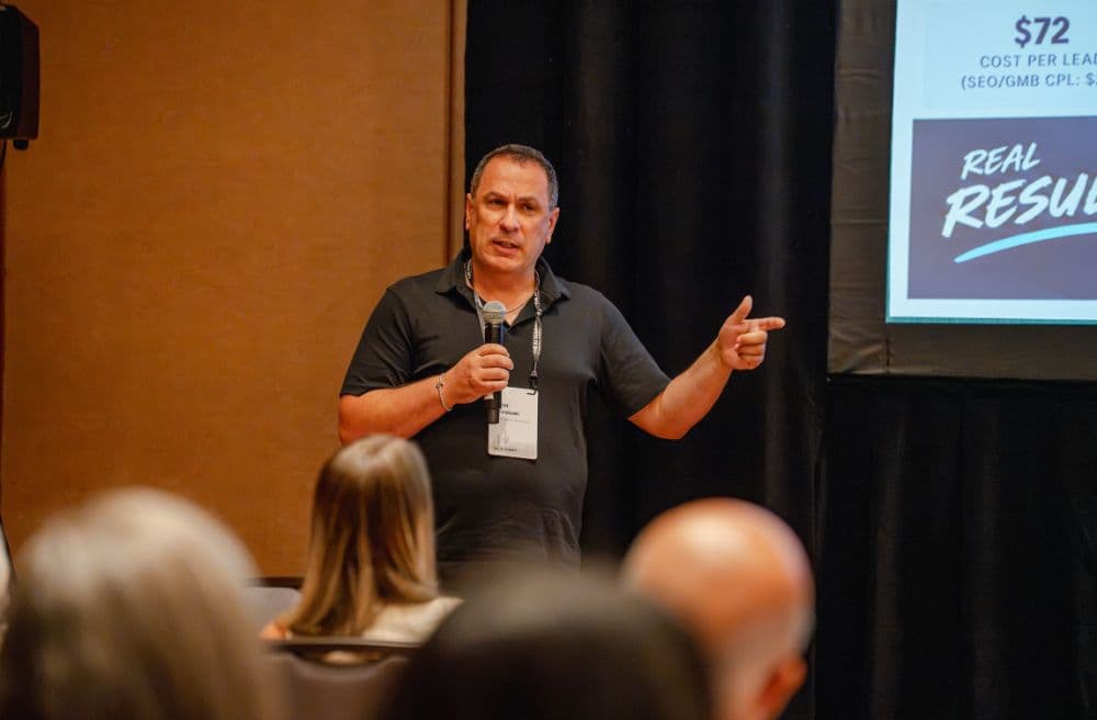 Speaker pointing toward the audience during a lightning talk