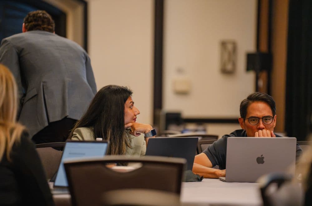 Two attendees working at laptops during Let's Build, Part 2