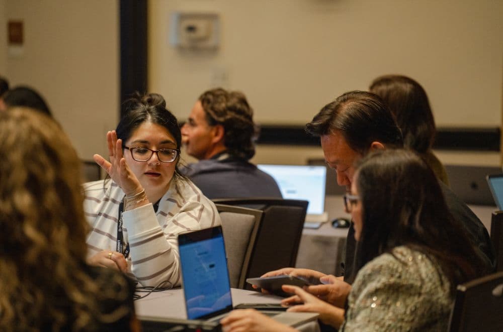 Attendees discussing their builds around a table during Let's Build, Part 2